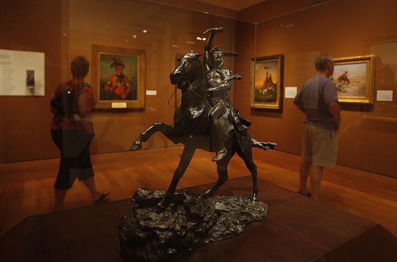 Patrons look at some of the pieces at the Booth Western Art Museum in Cartersville, Ga., on Saturday.