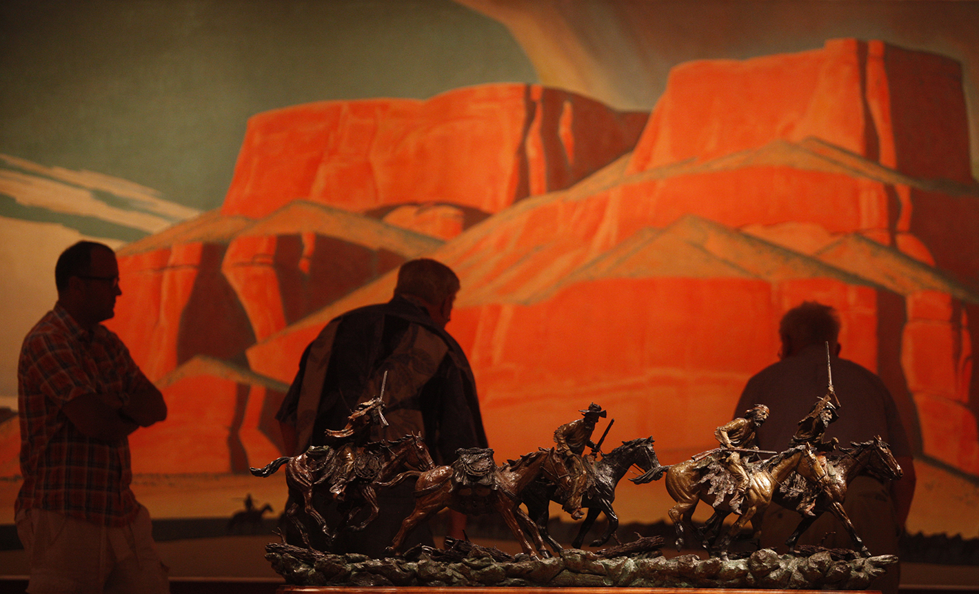 Patrons at the Booth Western Art Museum in Cartersville, Ga., look at pieces on display Saturday.