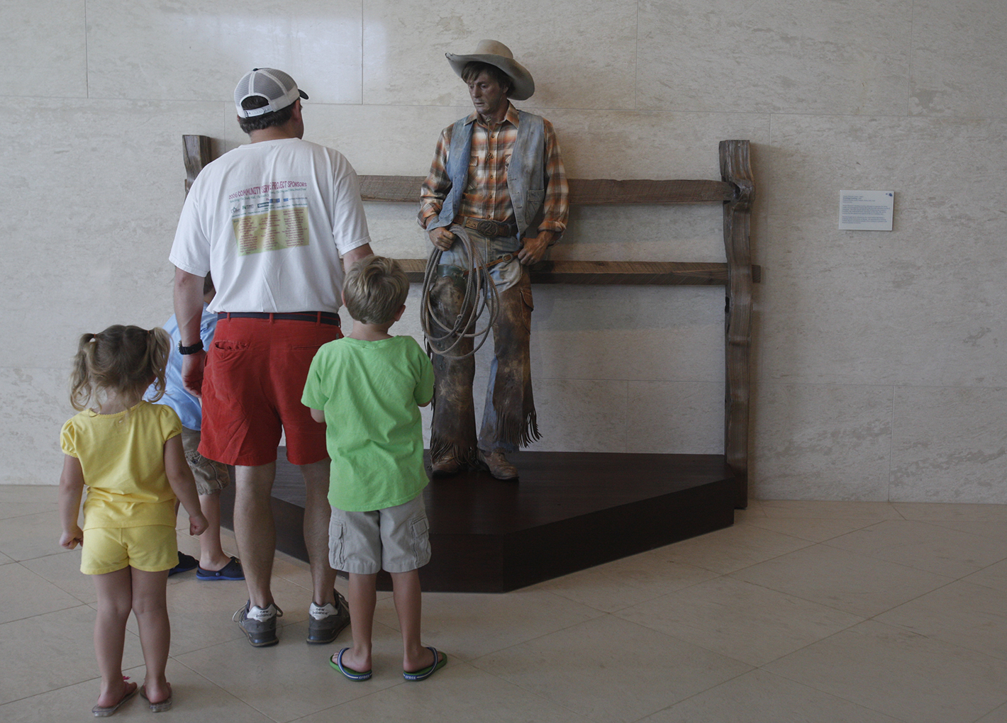Bob Burdell {CQ}, center, looks at a piece in the modern western wing at the Booth Western Art Museum in Cartersville, Ga., with his children, Sadie {CQ}, 4, and twins Charlie {CQ} and Jack {CQ}, 6, on Saturday.