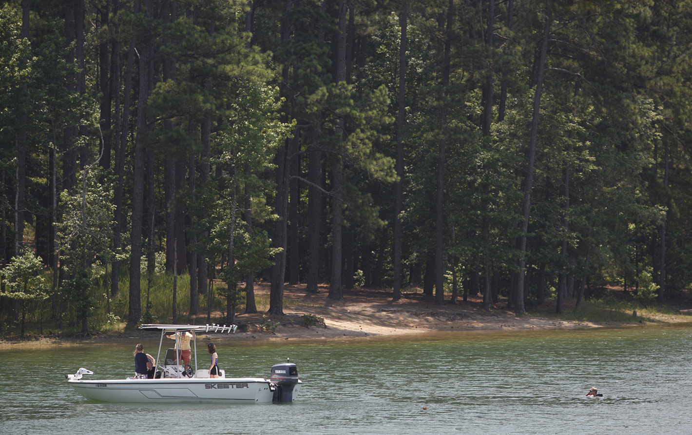 Boaters drift into a cove for a swim and some fishing at Lake Allatoona in Cartersville, Ga., on Saturday.