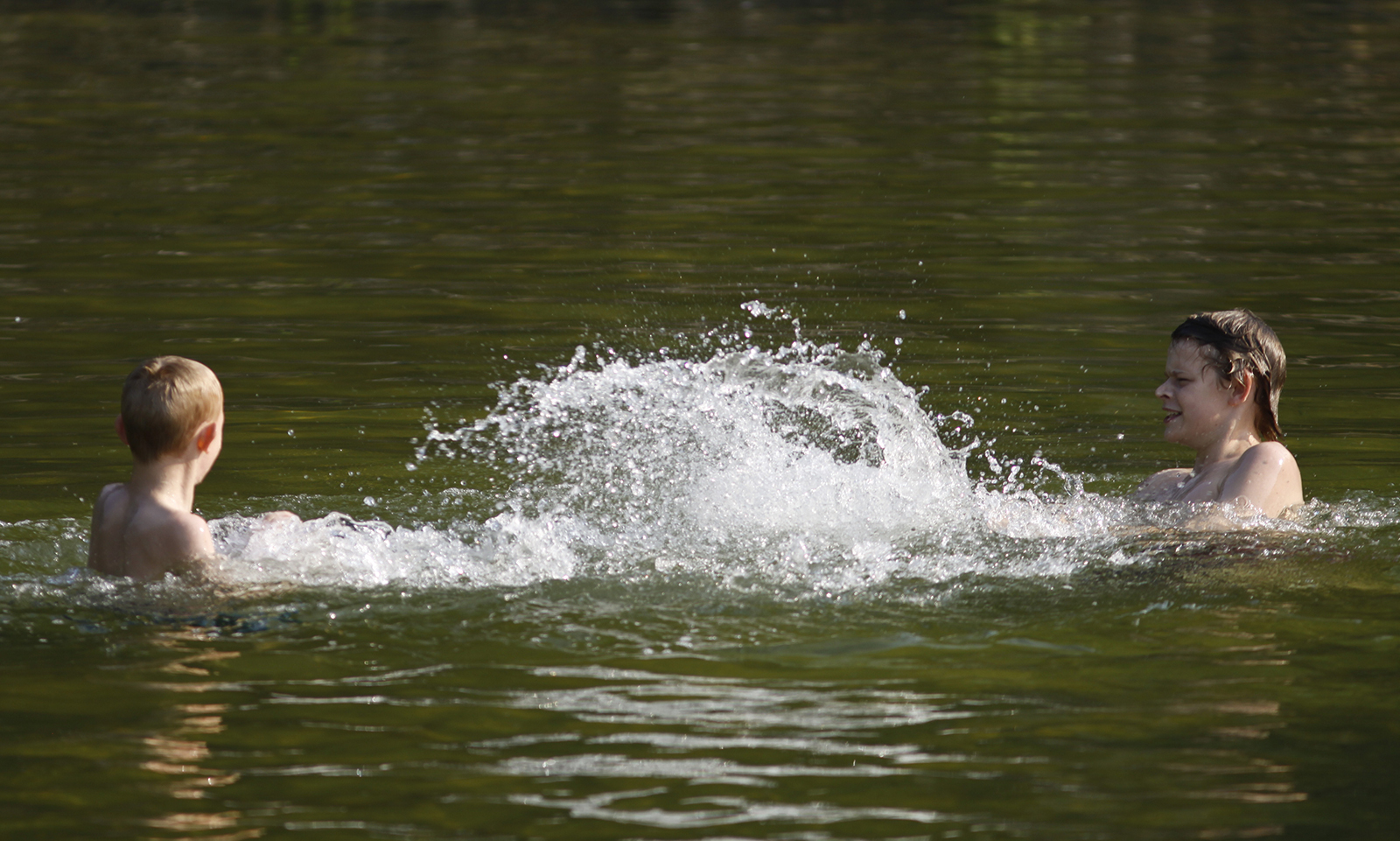 Staff photo by Dan Henry/Chattanooga Times Free Press - 6/09/11. Luke Waldrop, 7, left, and Chase Waldrop, 13, brothers from Gainesville, Ga., splash each other while swimming in Unicoi State Park's 53-acre Unicoi Lake on Smith Creek near the city of Helen nestled in the North Georgia mountains just a few hours drive from Chattanooga.