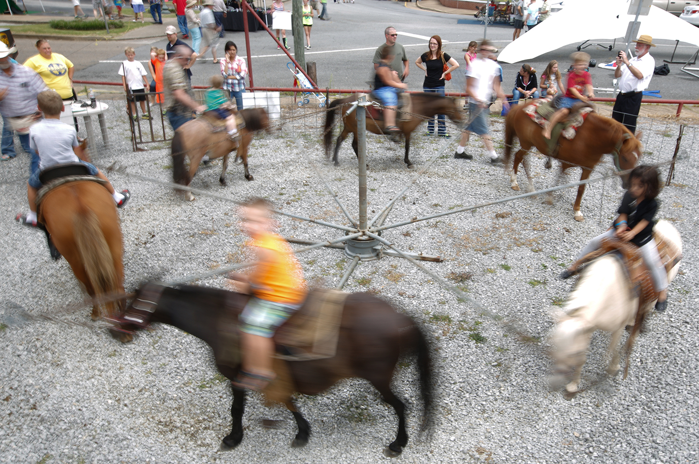 Children take pony rides Saturday, Aug. 2, 2014, at the Dade County Days Festival at Veterans Memorial Park in Trenton, Ga. The festival included a day of musical performances, vendors, inflatables, and a rubber duck race.