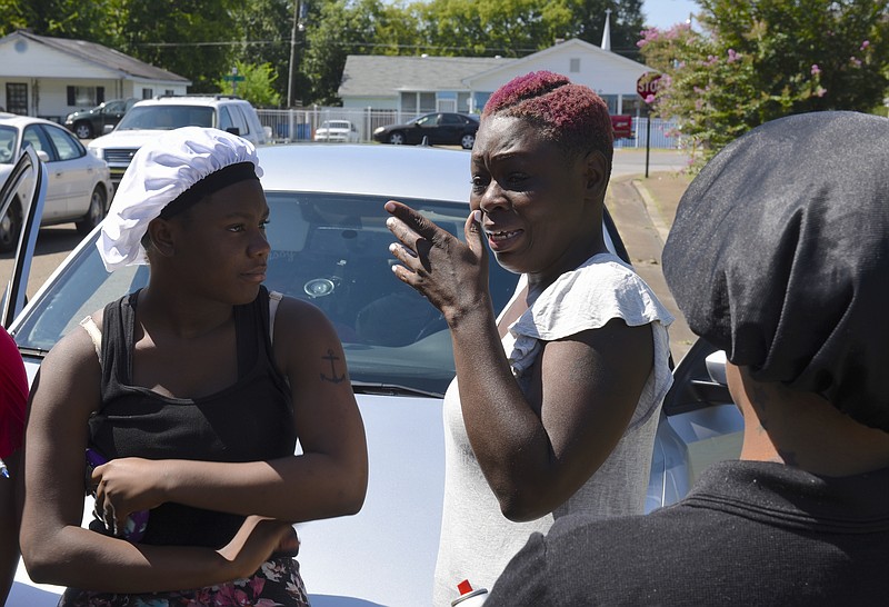 Satedra Smith, center, cries as she talks about her son,  20-year-old Frederick Jordan Clark, on Wednesday, Aug. 26, 2015, in Chattanooga, Tenn., in the aftermath of a Tuesday night shooting in the 800 block of North Willow Street that killed him. Clark's sister, Asia Smith, left, and cousin, Marquita Robinson stand with her on Willow Street at the scene of the shooting. 