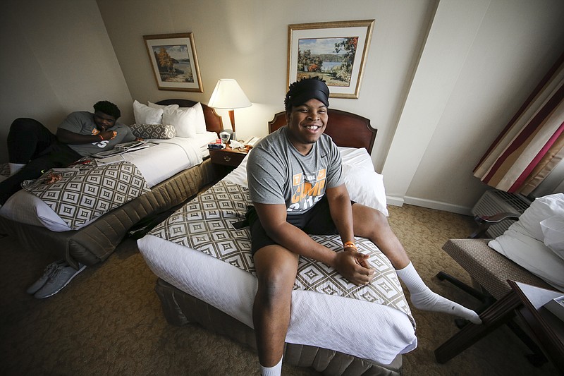 
              In this Aug 7, 2015 photo released by the University of Tennessee Athletics Department, offensive lineman Jashon Robertson, right, sits on a bed and works with a Sports Science Sleep Coach in a sleep study for the players in Knoxville, Tenn., at the university. Tennessee is studying its players’ sleep habits to make sure they don’t get caught napping when a game’s on the line. (Donald Page/Tennessee Athletics via AP)
            