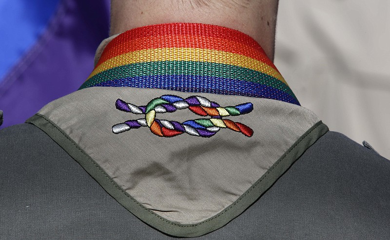 
              FILE - In this June 8, 2014, file photo, a Boy Scout wears his kerchief embroidered with a rainbow knot during Salt Lake City’s annual gay pride parade. The Mormon church, the nation's largest sponsor of Boy Scout units, is keeping its longtime affiliation with the organization despite its decision to allow gay troop leaders. Church leaders decided to stay with the Boy Scouts after getting assurances they can appoint troop leaders according to their own religious and moral values, The Church of Jesus Christ of Latter-day Saints said in a news release Wednesday, Aug. 26, 2015. (AP Photo/Rick Bowmer, File)
            