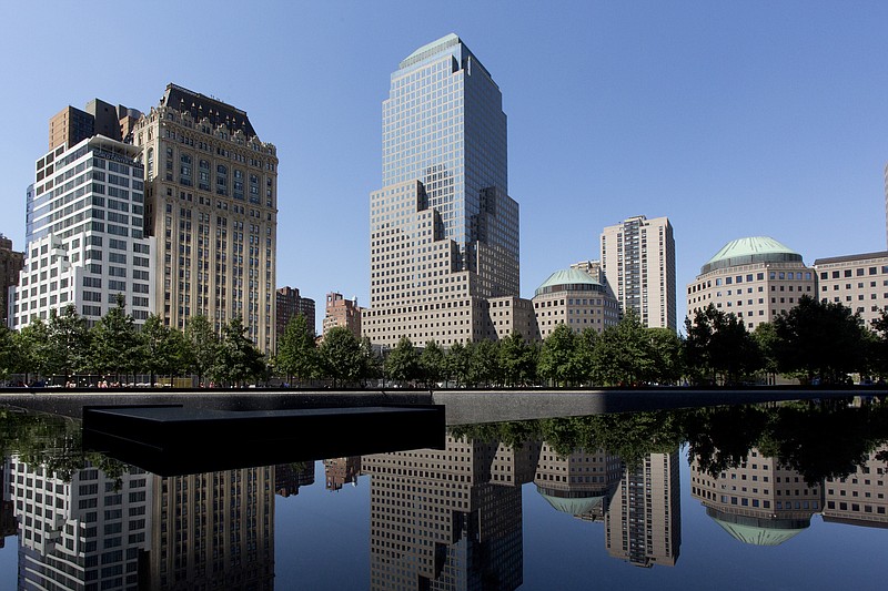 
              The office building at 200 Liberty Street, center, is reflected in one of two pools at the September 11 Memorial in New York on Wednesday, Aug. 26, 2015. The Associated Press plans to move its global headquarters from Manhattan's far west side to 200 Liberty St. in 2017, the news cooperative's President Gary Pruitt announced Wednesday. (AP Photo/Mark Lennihan)
            