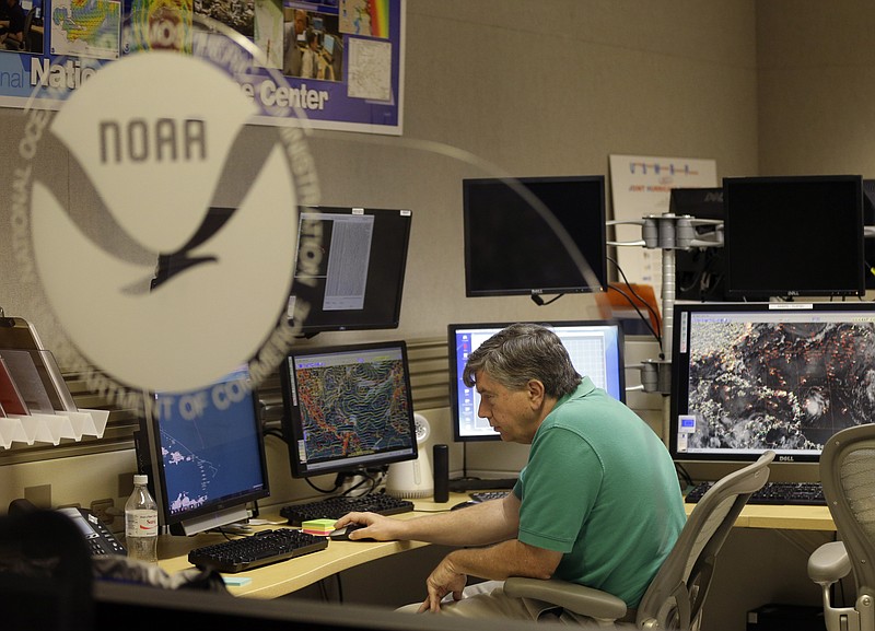 
              Jack Beven, senior hurricane specialist, tracks the movement of Tropical Storm Erika as it moves westward towards islands in the eastern Caribbean, at the National Hurricane Center, Wednesday, Aug. 26, 2015, in Miami. Tropical storm warnings have been issued for Puerto Rico, the U.S. and British Virgin Islands, and the Leeward islands. (AP Photo/Lynne Sladky)
            