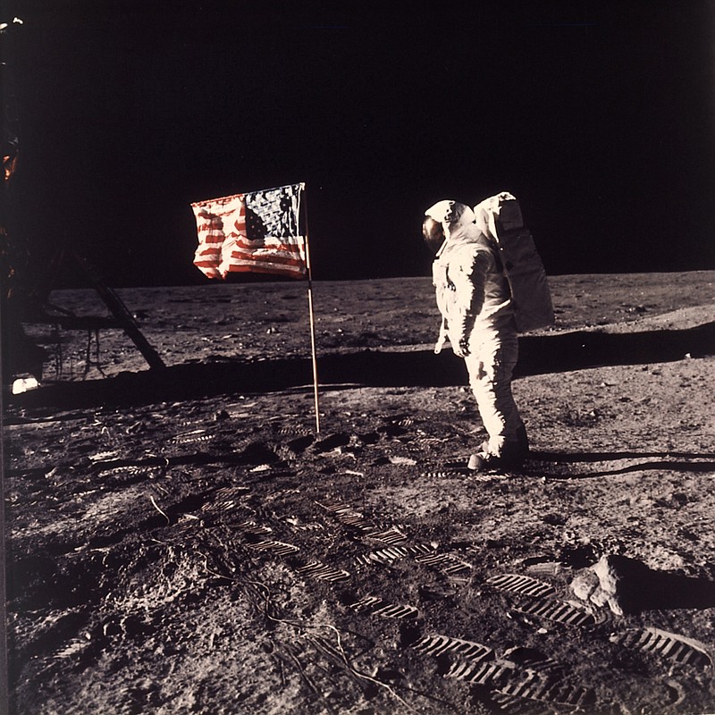 
              FILE - In this July 20, 1969 file photo, astronaut Edwin E. "Buzz" Aldrin Jr. stands next to a U.S. flag planted on the moon during the Apollo 11 mission. Aldrin and Neil Armstrong were the first men to walk on the lunar surface. During a ceremony in Melbourne, Fla. on Thursday, Aug. 27, 2015, Aldrin announced he is teaming up with the Florida Institute of Technology to develop "a master plan" for colonizing Mars within 25 years. (Neil A. Armstrong/NASA via AP)
            