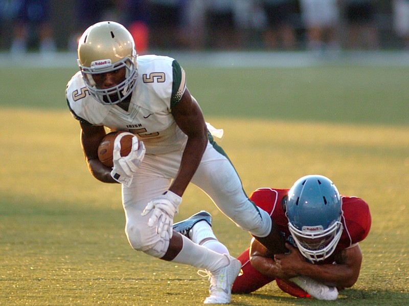 Notre Dame's Ricky Ballard lungs for extra yardage as a Brainerd defender hangs on.  The 2014 Best of Preps Times Free Press Jamboree second night of action was held at UTC's Finley Stadium.