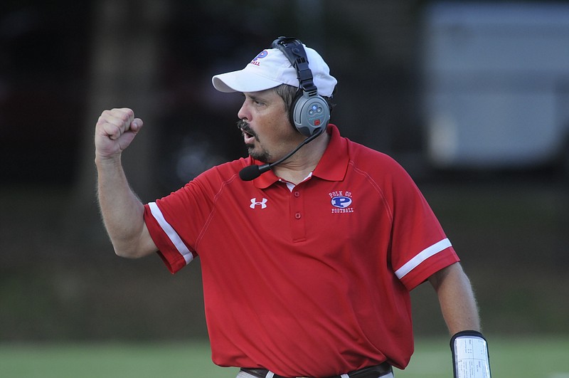 Polk County coach Derrick Davis pumps his fist at his team for encouragement during a 2015 game.