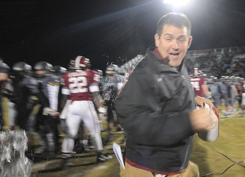 Southeast Whitfield's Sean Gray escapes a possible drenching after coaching the Raiders to their first playoff appearance in nearly three decades.