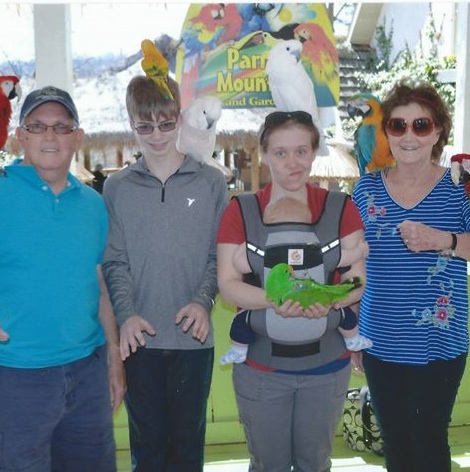 Well, sure, if you're going to Dollywood's Parrot Mountain, you need to document it with a photo of someone holding a parrot. Here, it's Natalie Tice, granddaughter to Fred Grove, far left. Next to Natalie is grandson Fred Irwin and grandmother Sharon Grove rounds out the quartet.