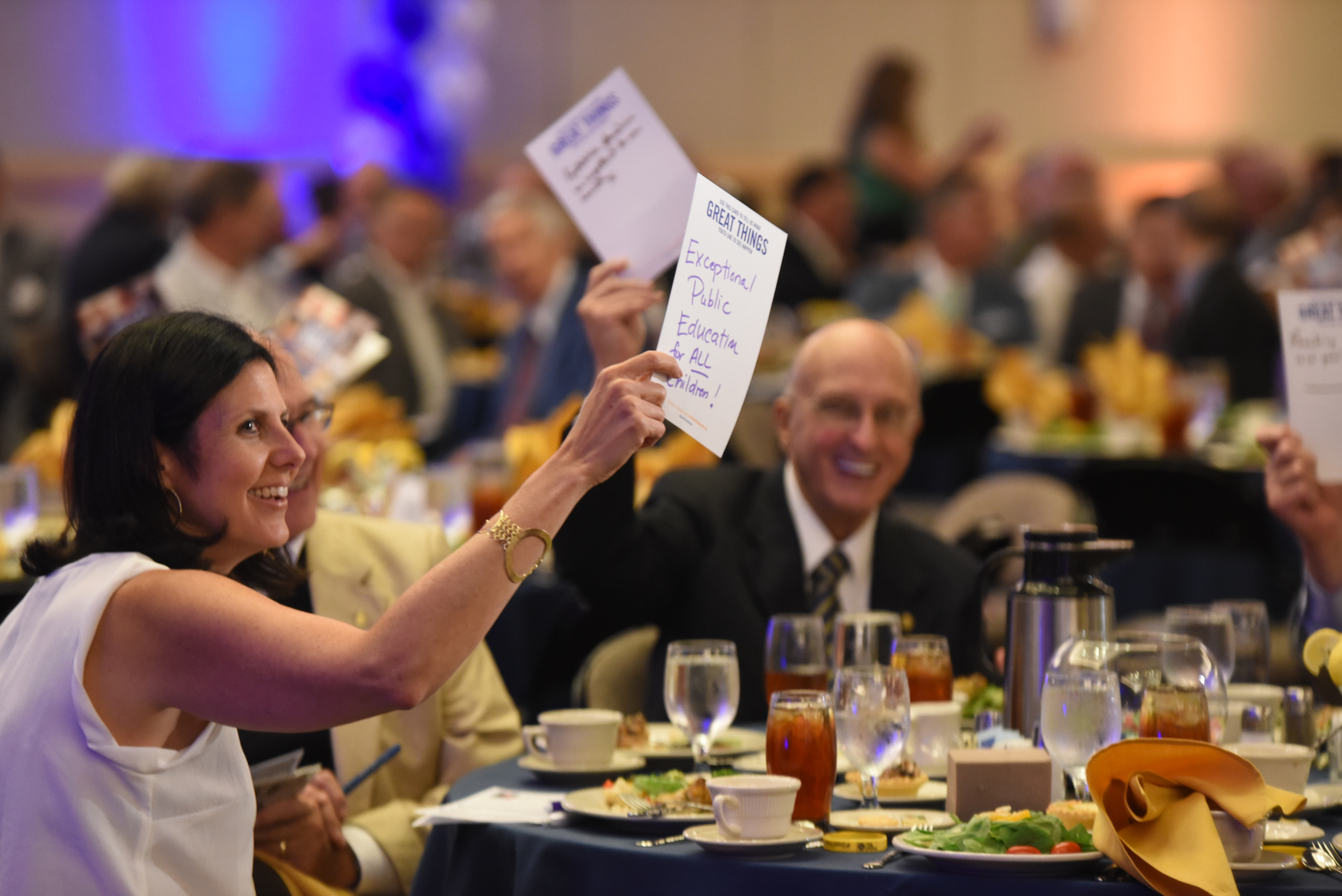 Alison Lebovitz, left, holds her hand written idea up at the outset of the United Way kickoff luncheon Thursday at the  Chattanooga Convention Center.