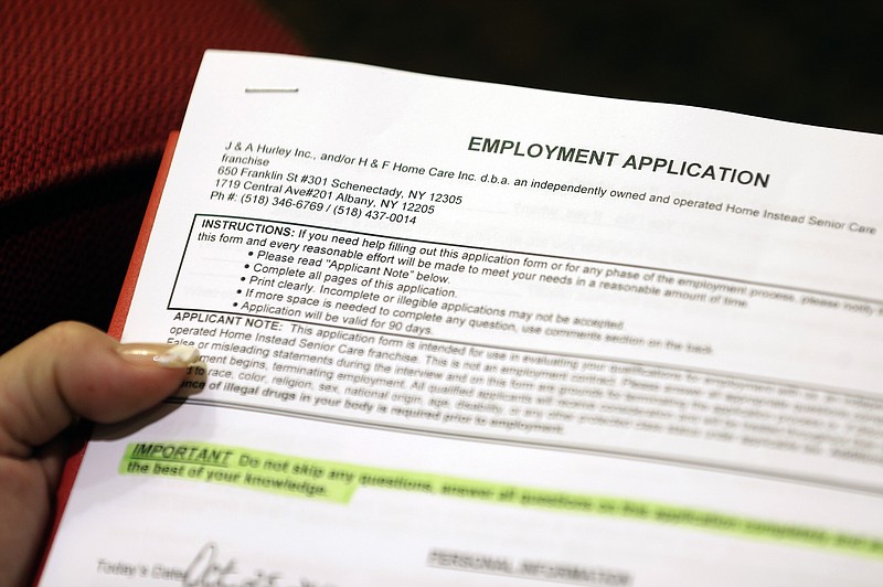 
              FILE - In this Thursday, Oct. 25, 2012, file photo, a job seeker fills out an employment application during a job fair at the Marriott Hotel in Colonie, N.Y. The Labor Department releases weekly jobless claims on Thursday, Aug. 27, 2015. (AP Photo/Mike Groll, File)
            