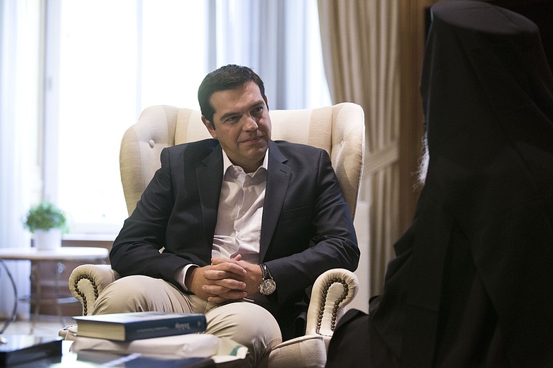 
              Outgoing Greek Prime Minister Alexis Tsipras listens to the Archbishop of Albania during their meeting in Athens, Tuesday, Aug. 25, 2015. Tsipras resigned on Thursday, Aug. 20 following a rebellion in his party over Greece's new bailout, which saw dozens of Syriza lawmakers dissent when the deal came to a vote in Parliament. (AP Photo/Petros Giannakouris)
            