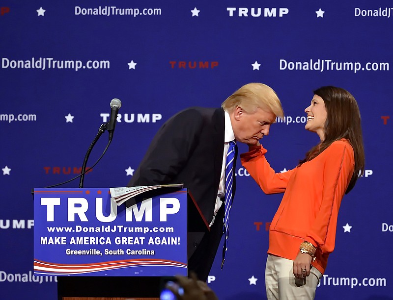 
              Republican presidential candidate Donald Trump supporter Mary Margaret Bannister checks to see if his hair is real during his speech at the TD Convention Center, Thursday, Aug,  27, 2015, in Greenville, S.C. Trump says his trademark hairdo is for real. He told 1,800 people in South Carolina Thursday: "It's my hair ... I swear." (AP Photo/Richard Shiro)
            