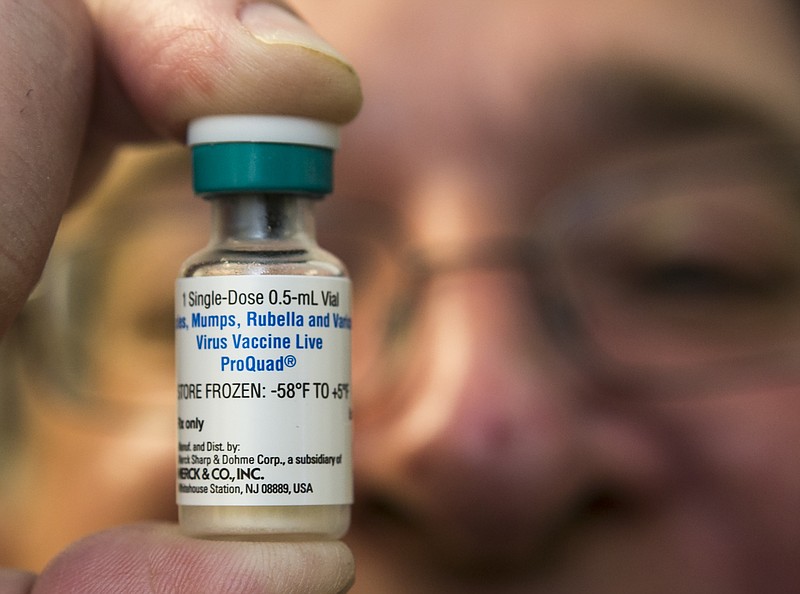 
              FILE - In this Thursday, Jan. 29, 2015 file photo, a pediatrician holds a dose of the measles-mumps-rubella (MMR) vaccine at his practice in Northridge, Calif. In 2014, only 21 states posted vaccination rates for individual schools, school districts, counties or areas of the state. The Centers for Disease Control and Prevention has been quietly prodding more states to make the information available. On Thursday, Aug. 27, 2015, the CDC's Dr. Anne Schuchat made the push more public during a news conference. (AP Photo/Damian Dovarganes)
            