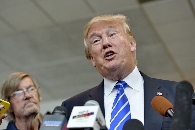 
              Republican presidential candidate Donald Trump answers questions from the media after speaking at a rally at the TD Convention Center, Thursday, Aug.  27, 2015, in Greenville, S.C. (AP Photo/Richard Shiro)
            