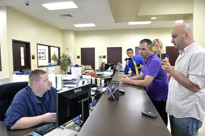 William Smith Jr., right, and his partner James Yates, second right, speak with an unnamed clerk in an attempt to obtain a marriage license at the Rowan County Courthouse in Morehead, Ky., Thursday, Aug. 27, 2015.