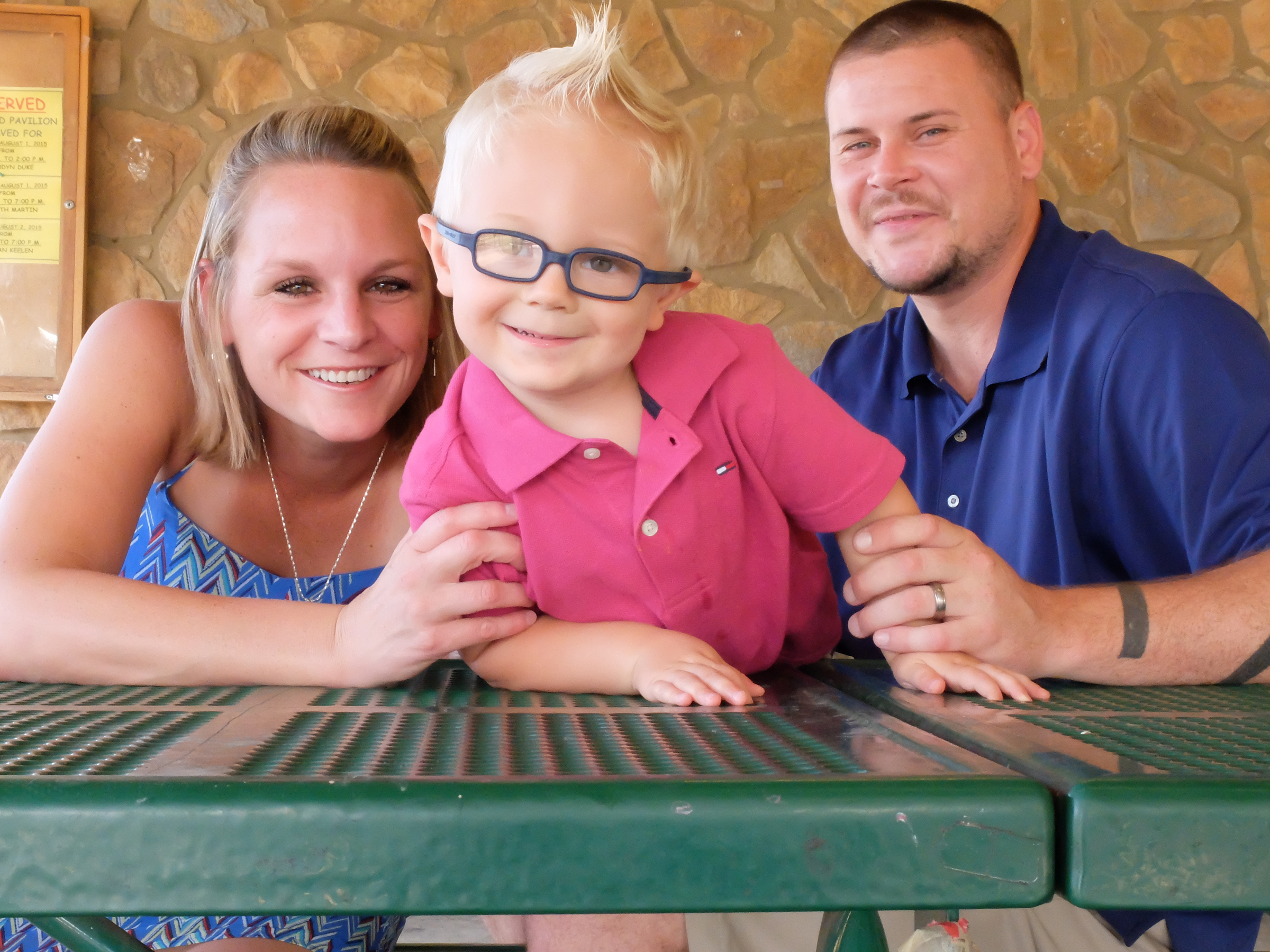 Chance Hall, 2, likes looking at the camera with his parents, Amy Hall, left, and Nolan Hall. Chance suffers from Klippel-Feil syndrome, a disease that affects the spine and causes his head to sit at an angle.