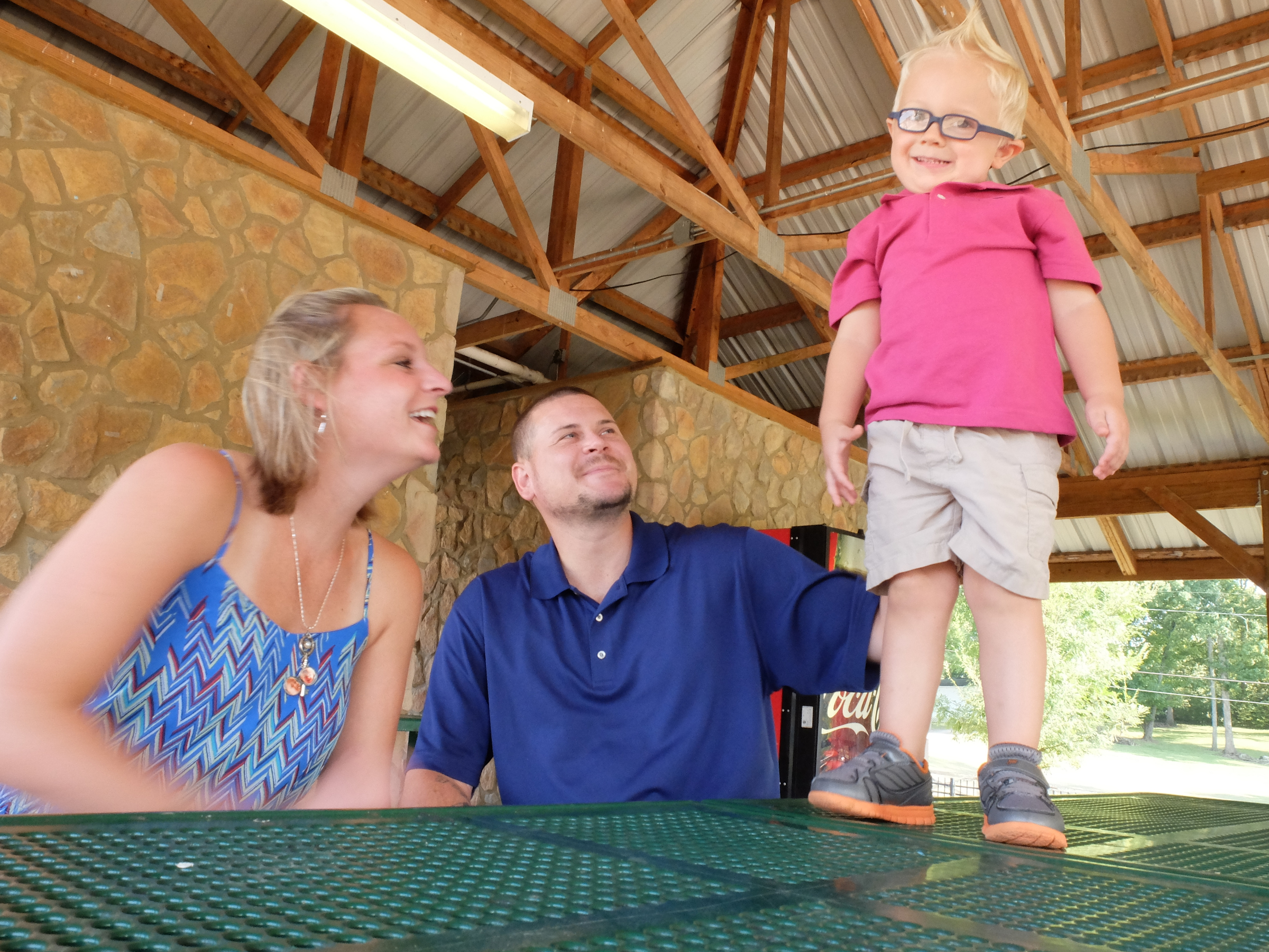 Staff photo by Tim Barber Chance Hall, 2, stands atop a picnic table as his mother and father, Amy and Nolan Hall, make him the center of their attention at Ringgold City Park.