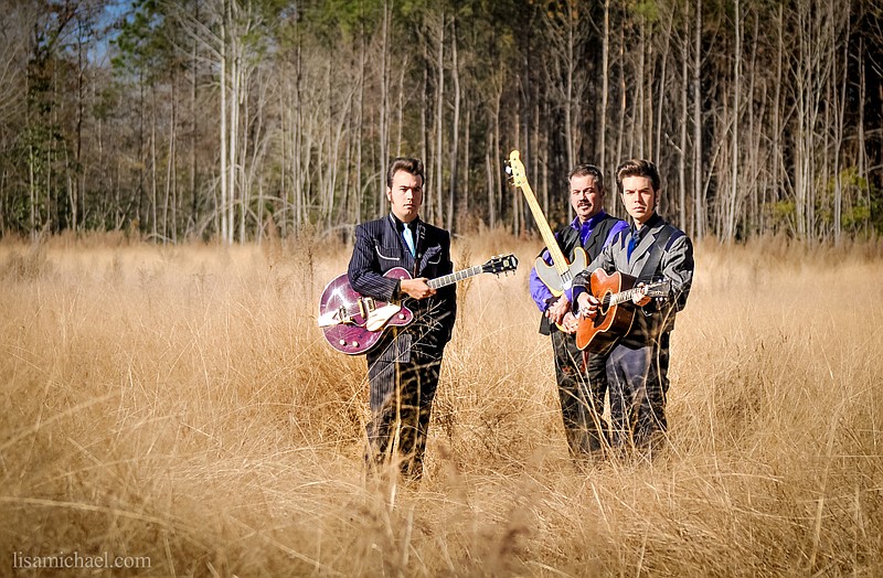 The Malpass Brothers, Christopher, left, and Tayler, right, are pictured with dad, Chris, who plays bass in the band.