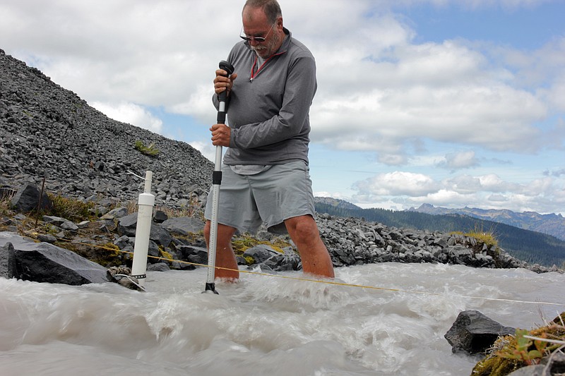 
              In this Aug. 7, 2015, photo scientist Oliver Grah measures the velocity of a stream of glacier melt stemming from Sholes Glacier in one of Mount Baker's slopes in Mount Baker, Wash. Glaciers on Mount Baker and other mountains in the North Cascades are thinning and retreating. (AP Photo/Manuel Valdes)
            