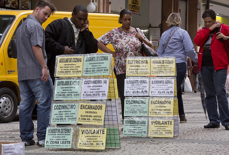 
              In this Tuesday, Aug. 25, 2015 photo, people look at job postings in downtown Sao Paulo, Brazil.  With an economy in recession, along with growing inflation and unemployment, President Dilma Rousseff has the worst approval rating for any president since Brazil’s return to democracy. (AP Photo/Andre Penner)
            