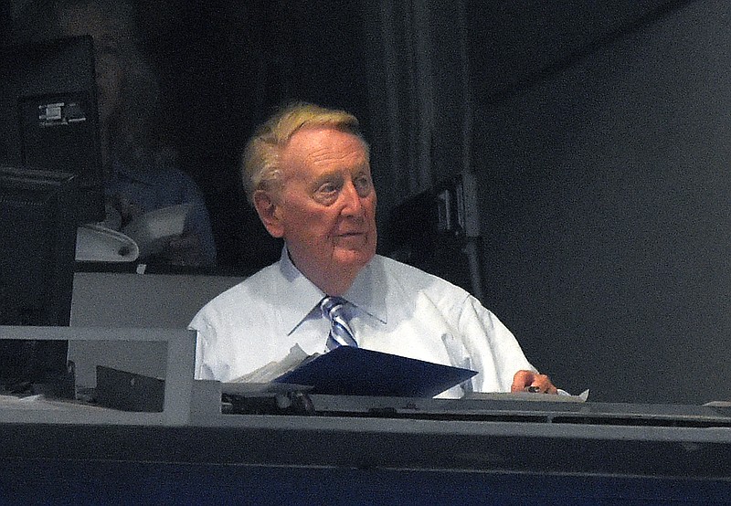 
              Los Angeles Dodgers Hall of Fame announcer Vin Scully sits in his booth during the third inning of a baseball game between the Dodgers and the Chicago Cubs, Friday, Aug. 28, 2015, in Los Angeles. (AP Photo/Mark J. Terrill)
            
