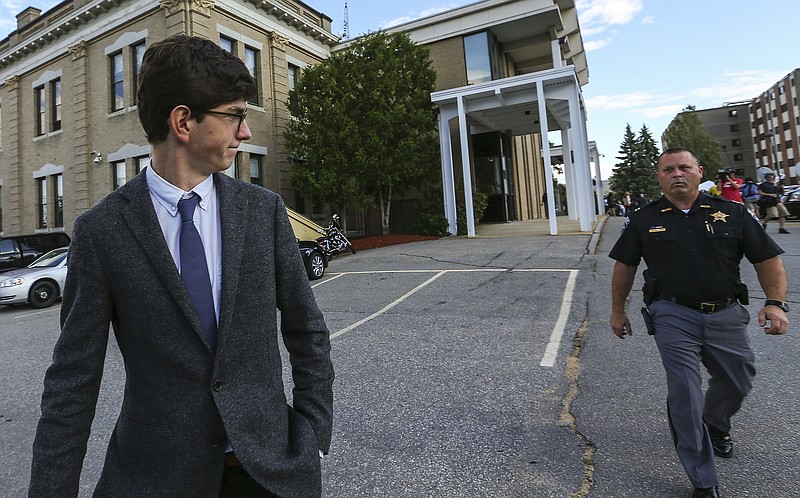 Former St. Paul's School student Owen Labrie, left, leaves the Merrimack Superior Court at the end of day with security in tow.