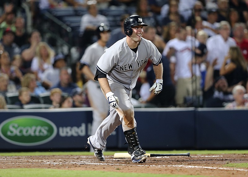 New York Yankees catcher Brian McCann (34) follows through on a three-run home run against Atlanta Braves in the eighth inning of a baseball game Friday, Aug. 28, 2015, in Atlanta.