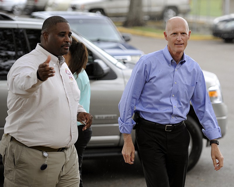 
              Gov. Rick Scott, right, is greeted by Hillsborough County Emergency Operations Center Manager Preston Cook in Tampa, Fla. on Friday, Aug. 28, 2015. The governor and several local officials were on hand at the county E.O.C. to discuss Tropical Storm Erika and its possible impact on the state. (Chris Urso/The Tampa Tribune via AP)  ST. PETERSBURG OUT; LAKELAND OUT; BRADENTON OUT; MAGS OUT; LOCAL TELEVISION OUT; WTSP CH 10 OUT; WFTS CH 28 OUT; WTVT CH 13 OUT; BAYNEWS 9 OUT; THE TAMPA BAY TIMES OUT; LAKELAND LEDGER OUT; BRADENTON HERALD OUT; SARASOTA HERALD-TRIBUNE OUT; WINTER HAVEN NEWS CHIEF OUT; MANDATORY CREDIT
            