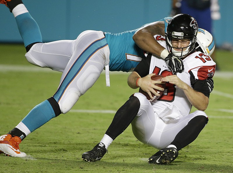 Atlanta Falcons quarterback T.J. Yates (13) is sacked by Miami Dolphins guard Bryant Browning (79) during their game, Saturday, Aug. 29, 2015 in Miami Gardens, Fla.