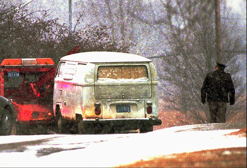 A truck pulls Dr. Jack Kevorkian's minivan away from a parking lot at the Medical Examiner's office in Pontiac, Mich., in this 1996 file photo. Authorities said contained the body of a woman. 