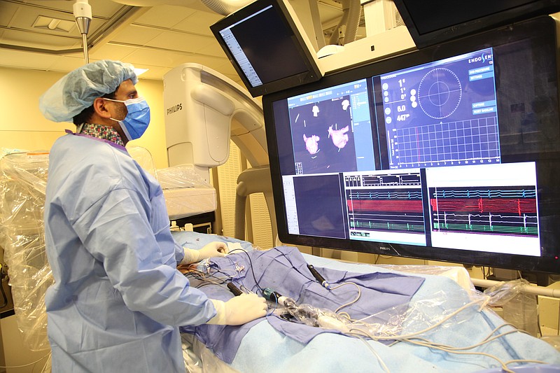 
              In this undated image provided on Saturday Aug. 29, 2015  by Mount Sinai Hospital in New York shows Dr Vivek Reddy as he checks the screen  while doing a surgery to implant the new tiny  wireless pacemaker at the Mount Sinai hospital in New York . Unlike traditional pacemakers — which need a generator and wires and are implanted via surgery — the new pacemaker is a wireless tiny tube that can be attached to the right side of the heart using a catheter inserted through the leg. (Mount Sinai Hospital via AP) NO ARCHIVE NO SALES
            