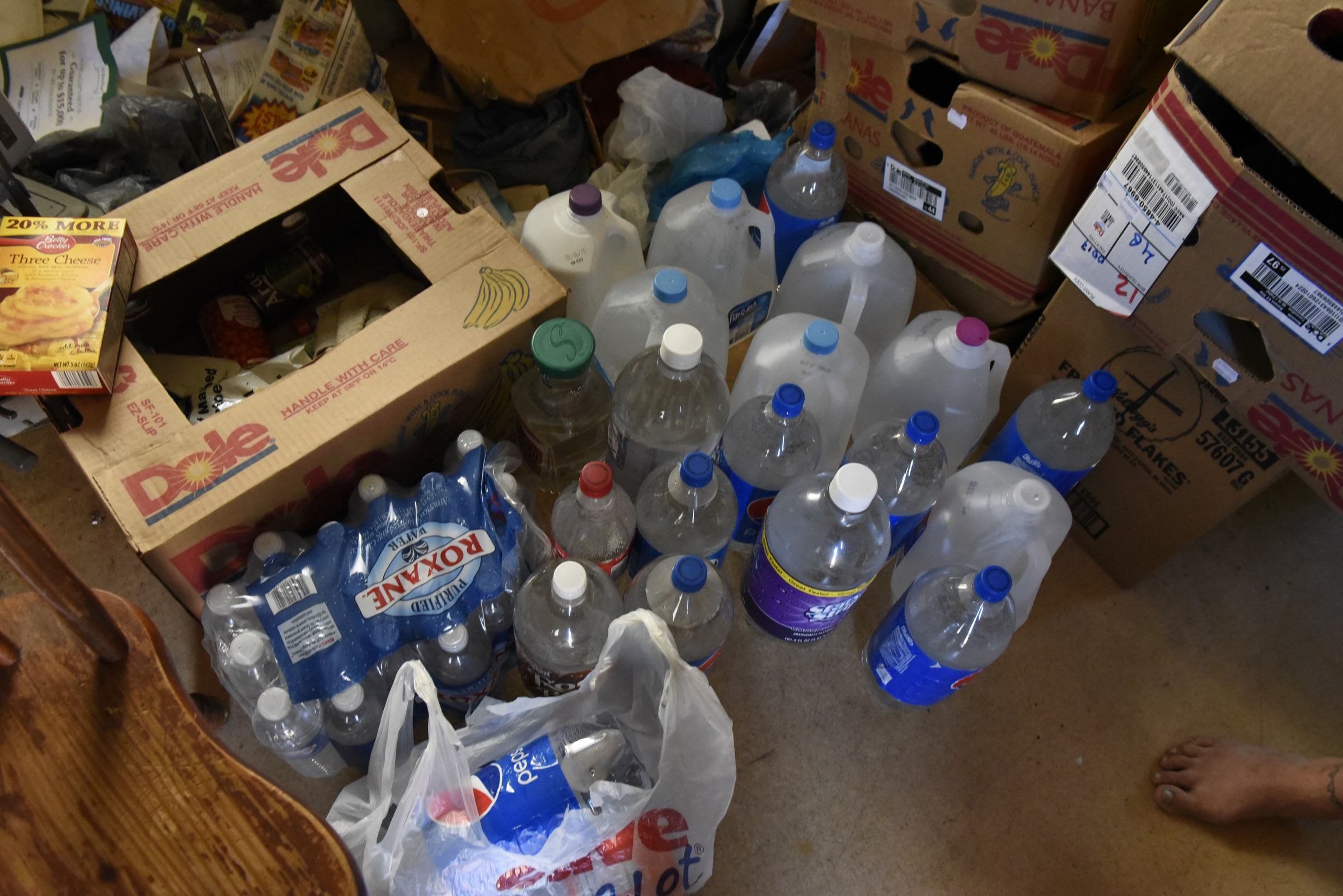 Nikki Cortez keeps bottles of water on the floor of her residence at the Pear Pines Mobile Home Park on Tuesday, Aug. 25, 2015, in LaFayette, Ga. Few residents remain after the landlord's financial problems caused water to be turned off at the property several weeks ago.