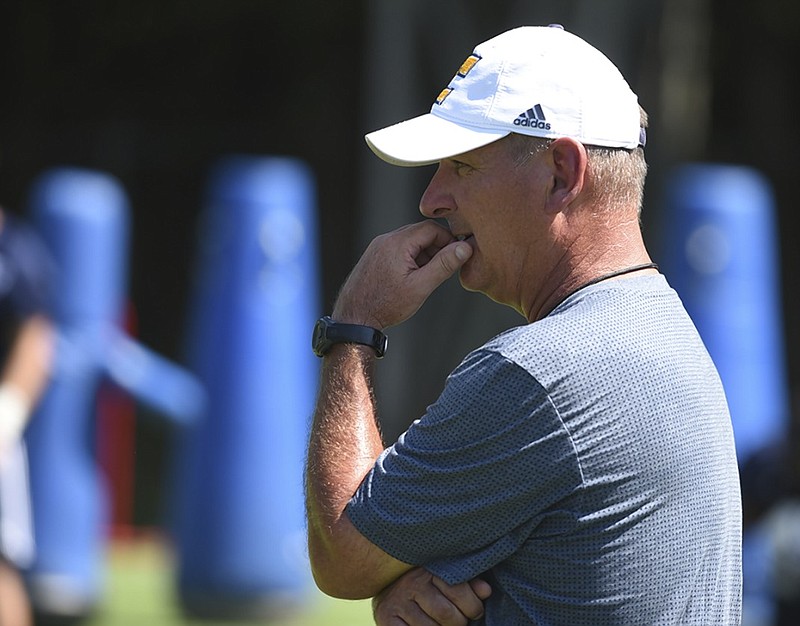 UTC football coach Russ Huesman watches his team during the first day of preseason camp earlier this month. Today, Huesman is five days away from the start of his seventh season leading the Mocs, who hope this year finishes with them celebrating their first national championship.