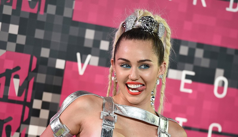 Miley Cyrus arrives at the MTV Video Music Awards at the Microsoft Theater on Sunday, Aug. 30, 2015, in Los Angeles.