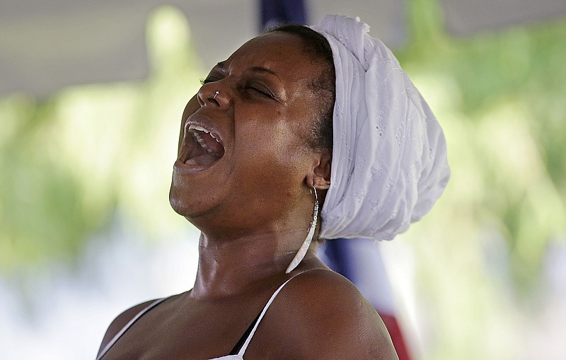 
              Michaela Harrison sings a gospel hymn at a wreath laying ceremony at the Hurricane Katrina Memorial, on the 10th anniversary of Hurricane Katrina in New Orleans, Saturday, Aug. 29, 2015. (AP Photo/Gerald Herbert)
            