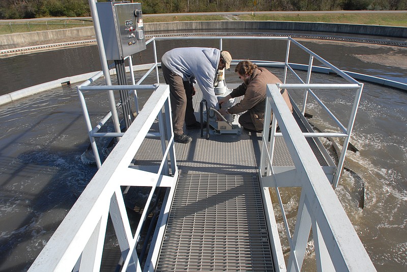 William Morgan, left, and Brian Cate make an adjustment on the drive of a wet weather water clarifier at the Moccasin Bend Wastewater Treatment Plant. The wet weather tanks are only used during significant rains. 