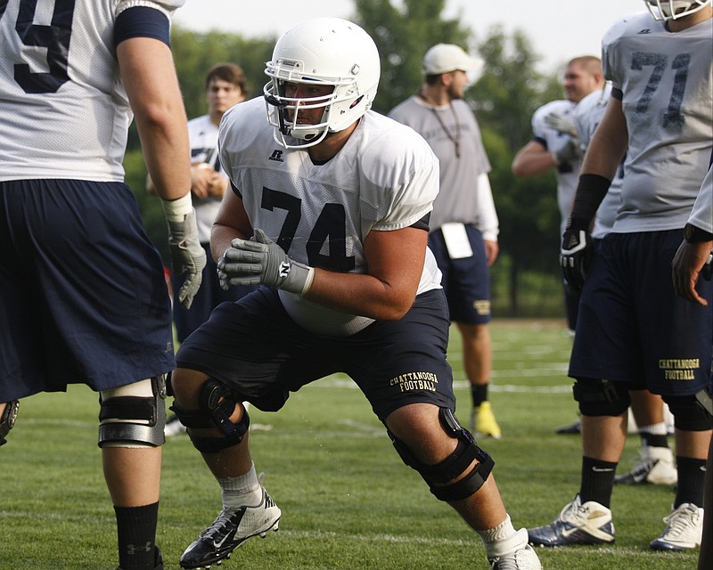 Staff Photo by Doug Strickland - UTC offensive lineman Synjen Herren (74) runs a blocking drill during the Mocs' 3rd practice of the preseason Friday, Aug. 2, 2013, at Scrappy Moore Field in Chattanooga, Tenn.