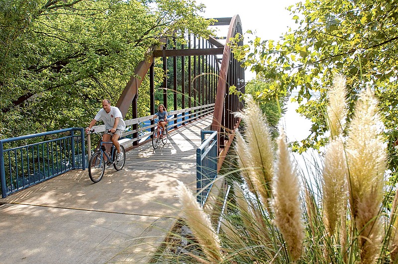 Bicyclists cruise along the Tennessee Riverwalk near downtown Chattanooga.