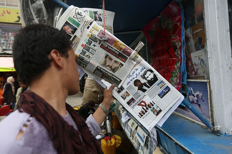 
              FILE - In this Aug. 1, 2015 file photo, an Afghan reads local newspapers carrying headlines about the new leader of the Afghan Taliban, Mullah Akhtar Mansoor, and former leader Mullah Mohammad Omar who was declared dead, on display at a newsstand in Kabul, Afghanistan. Defying the fury of Afghanistan’s government and warnings from Washington, Pakistani authorities appear to be turning a blind eye to a meeting of hundreds of Taliban followers in Quetta, Pakistan, near the Afghan border, aimed at resolving a dispute over the group’s leadership following the announcement of the death of one-eyed figurehead Mullah Mohammad Omar. (AP Photo/Rahmat Gul, File)
            