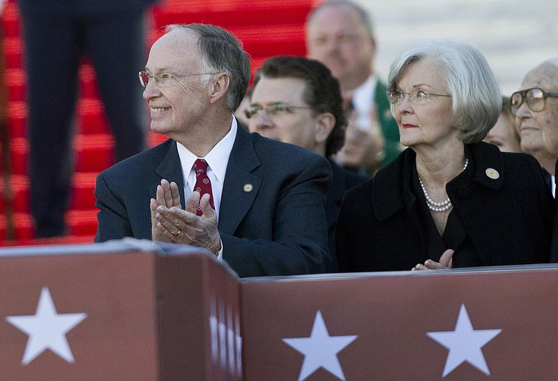 In this Monday, Jan. 19, 2015, file photo, Alabama Gov. Robert Bentley, and his wife Dianne Bentley applaud during a speech before Bentley is inaugurated for his second term, at the state Capitol in Montgomery, Ala.