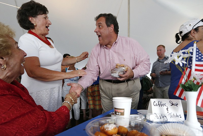 
              Republican presidential candidate, New Jersey Gov. Chris Christie, center, greets people during a campaign stop at a Greek festival in Manchester, N.H., Saturday, Aug. 29, 2015. (AP Photo/Michael Dwyer)
            