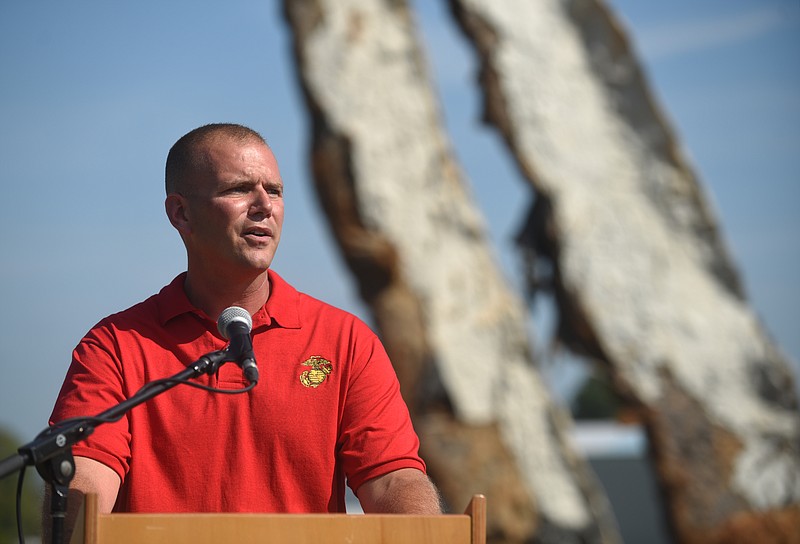 Marine Capt. Chris Cotton speaks as a crane raises a 65-foot-tall sculpture Tuesday, Sept. 1, 2015, at the Sculpture Fields at Montague Park as a tribute to honor the five military members who were slain in July. Artist Peter Lundberg created the sculpture, named Anchors.