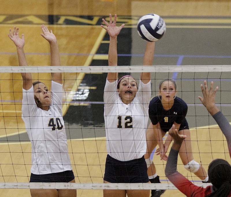 Soddy-Daisy's Rachel Rader, right, and Cameren Swafford jump to block an Ooltewah spike during their prep volleyball game at Soddy-Daisy High School on Tuesday, Sept. 1, 2015, in Soddy-Daisy, Tenn. Ooltewah won the matchup, which pitted Ooltewah head coach Elaine Peigen against her daughter, Soddy-Daisy head coach Libby Peigen, with a score of 3-0.