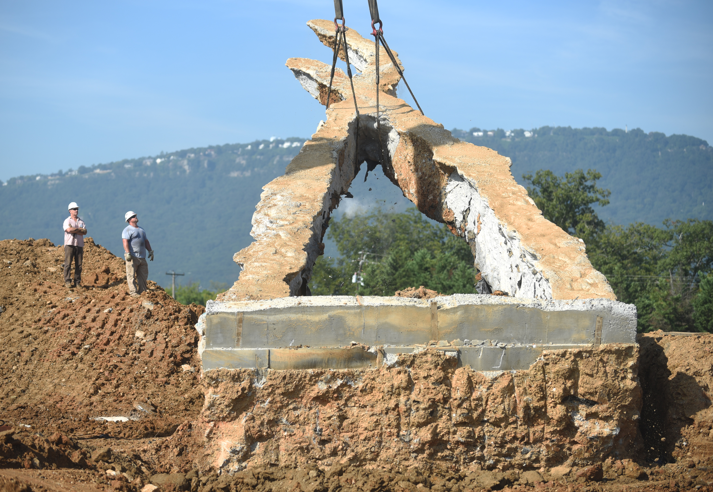 A crane raises a 65-foot-tall sculpture Tuesday, September 1, 2015, at the Sculpture Fields at Montague Park as a tribute to honor the five military members who were slain in July. Artist Peter Lundberg created the sculpture, named Anchors.