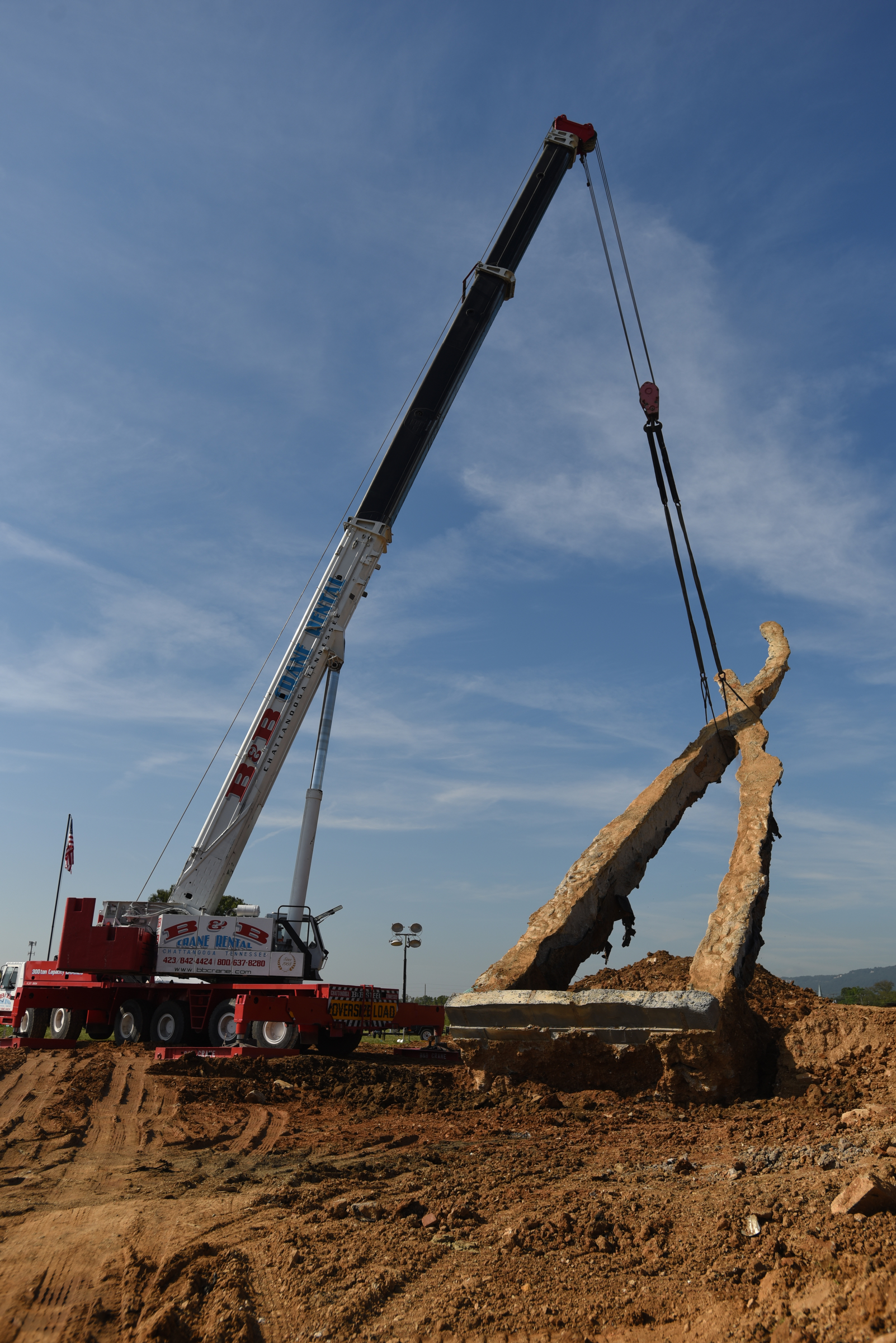 A crane raises a 65-foot-tall sculpture Tuesday, September 1, 2015, at the Sculpture Fields at Montague Park as a tribute to honor the five military members who were slain in July. Artist Peter Lundberg created the sculpture, named Anchors.