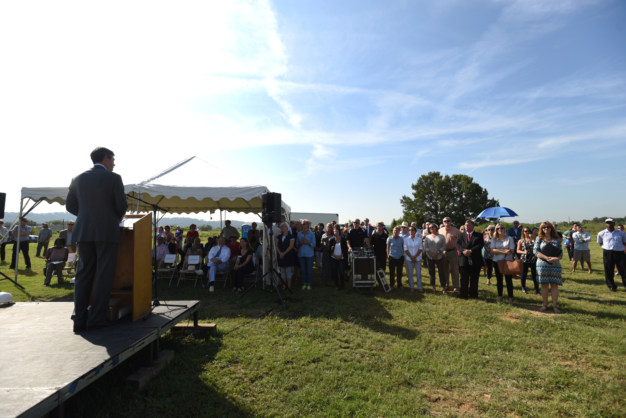 People watch as a crane raises a 65-foot-tall sculpture Tuesday, September 1, 2015, at the Sculpture Fields at Montague Park as a tribute to honor the five military members who were slain in July. Artist Peter Lundberg created the sculpture, named Anchors.